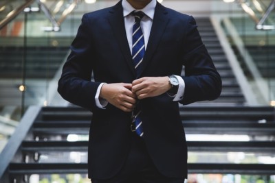 pic of corporate suit with watch by Hunters Race via Unsplash