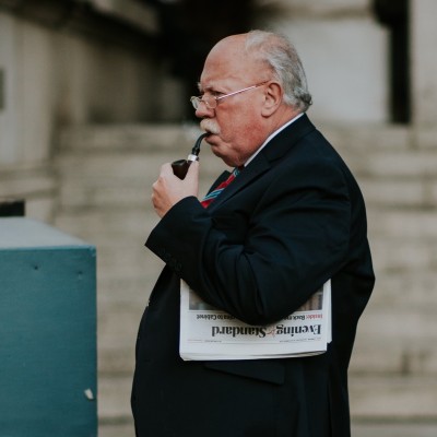 Photo of businessman with pipe by Joel Barwick via Unsplash