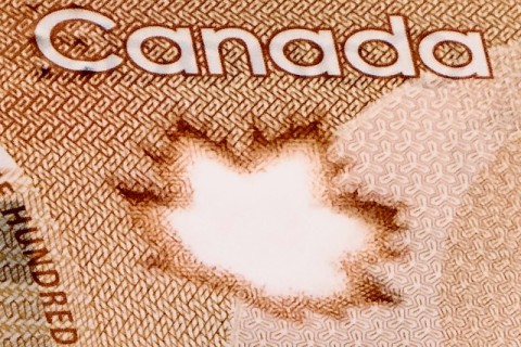Photo of Maple Leaf on $100 bill by PiggyBank via Unsplash