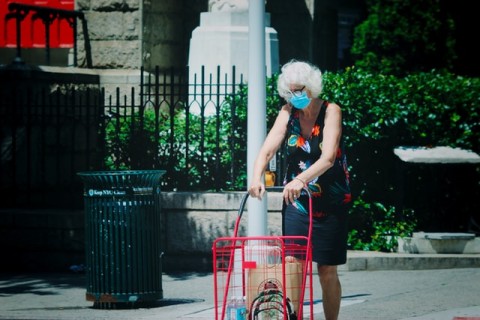 Elderly Woman with groceries by Jon Tyson on Unsplash