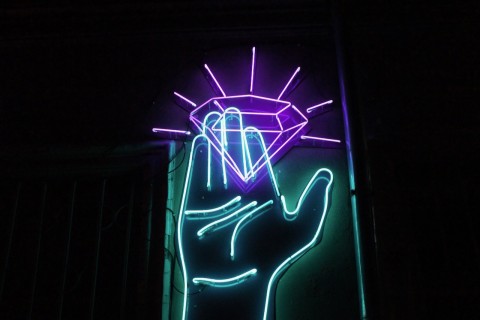 neon light diamond in hand photo Yuri Bodrikhin Unsplash