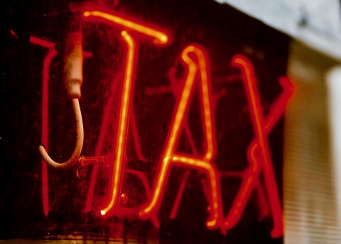 Tax neon sign photo Jon Tyson Unsplash Canadians for Tax Fairness