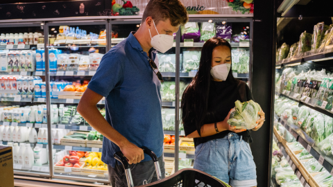 couple at grocery store wearing masks 