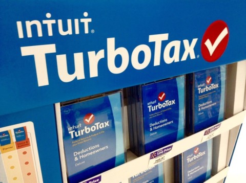 A photo of TurboTax advertizing; white letters on a blue background with a white check on a red circle