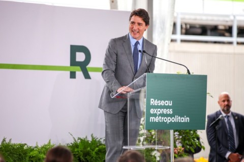 Trudeau smiling at a podium