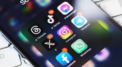 Photo of a closeup of a phone screen featuring different apps with a black background