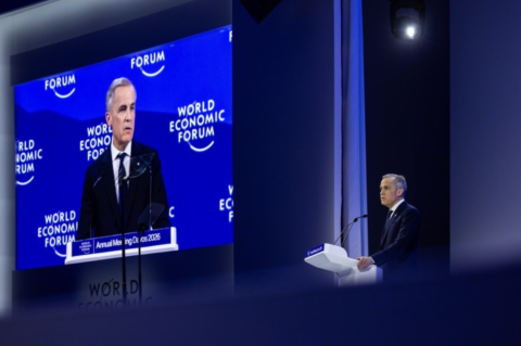 Carney on a screen and at a podium speaking at Davos 2026