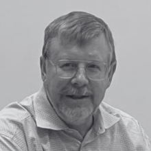 A black and white headshot of Andrew McNeill