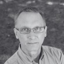 A black and white headshot of David Bruer