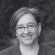 A black and white headshot of Angella MacEwan